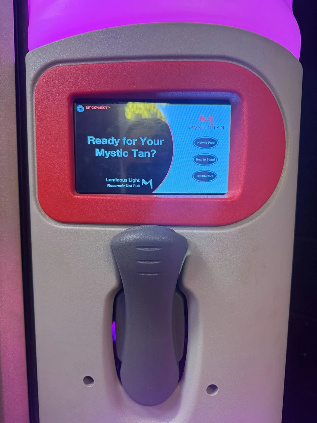Mystic Tan booth controls during a spray tan session